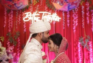 groom kissing on bride head